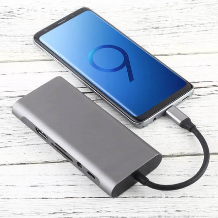 USB-C Hub with Multiple Ports for Device Connectivity Expansion connected to smartphone and external monitor and USB devices