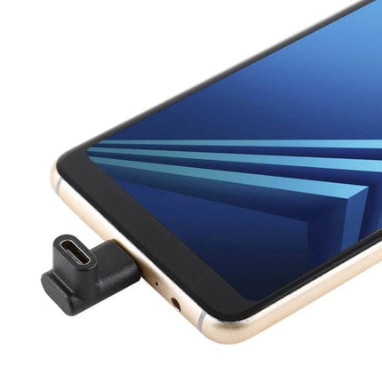 Elbow Design USB-C Extension Adapter for Charging and Data Transfer plugged into smartphone for tight-space charging and data access