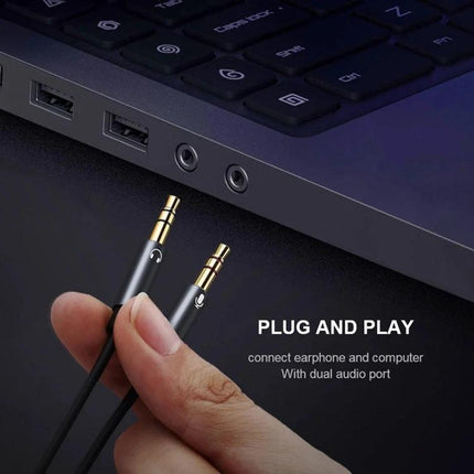 Compact Audio Cable for Daily Device Connections and Calls - hand holding gold-plated 3.5mm plug near laptop dual audio ports