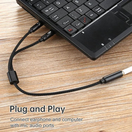 Compact Audio Cable for Daily Device Connections and Calls — black braided 3.5mm aux cable plugged into laptop for music and calls