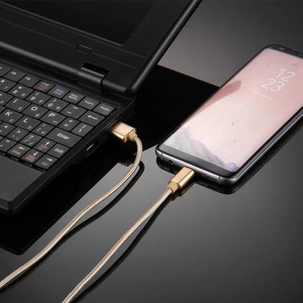 Knit USB-C Cable for Everyday Device Charging and Syncing connected between laptop and smartphone, gold braided design for commuting and quick sync