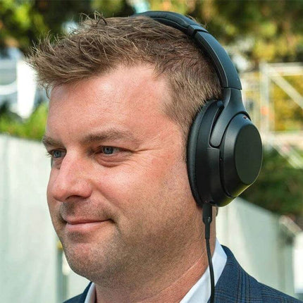 Replacement Audio Cable for Sony Headphones, 1.5m Length connected to over-ear headphones on man listening outdoors