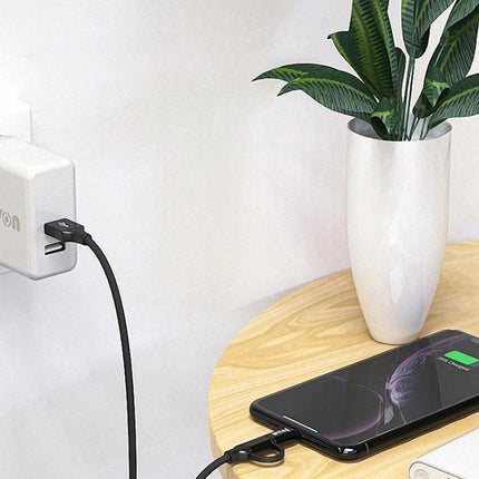 IVON 2-in-1 Cable for Everyday Device Charging and Syncing connected to wall charger and smartphone on bedside table, charging and syncing