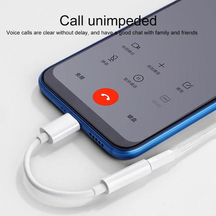 Daily Adapter for 3.5mm Headphones on Type-C Devices plugged into phone during a call, compact white plug-and-play adapter