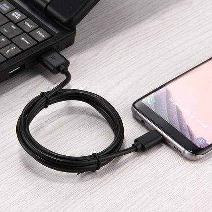 Cable for Charging Devices in Daily Home and Travel Use - Type-C charging cable connecting smartphone to laptop on desk