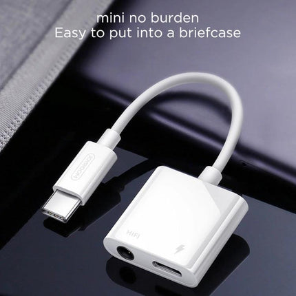 Joyroom Adapter for Daily USB-C Audio Connections - compact white USB-C to 3.5mm audio + charging adapter shown on a desk, portable briefcase-friendly