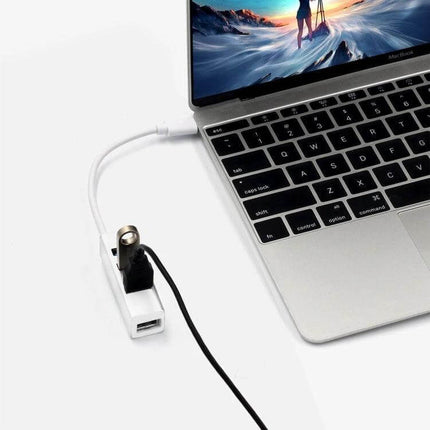 USB-C 4-Port USB Hub Adapter for Laptops and Devices connected to a laptop with USB accessories attached