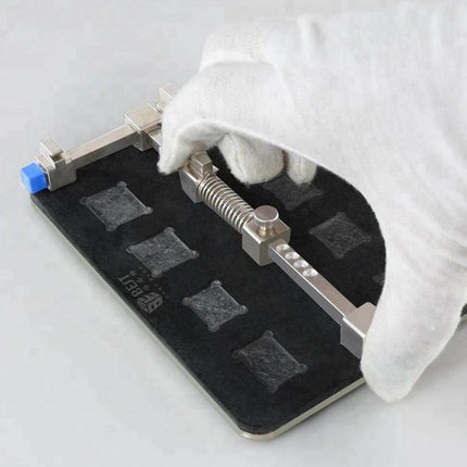 Professional Stainless Steel PCB Holder for Circuit Board Repair securing a smartphone PCB on foam pad for precise chip soldering