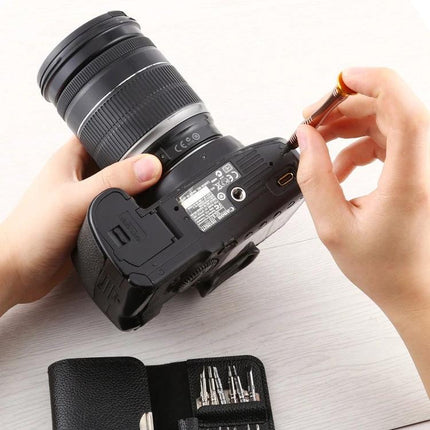Comprehensive 16-in-1 Screwdriver and Repair Tool Set for Mobile Devices being used to repair a digital camera with precision bits