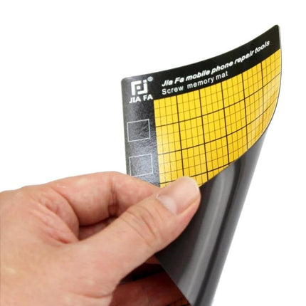 Universal Magnetic Screw Mat for Phone Repair and Organization, 14.5x9cm - hand holding yellow grid magnetic screw memory mat for phone repairs