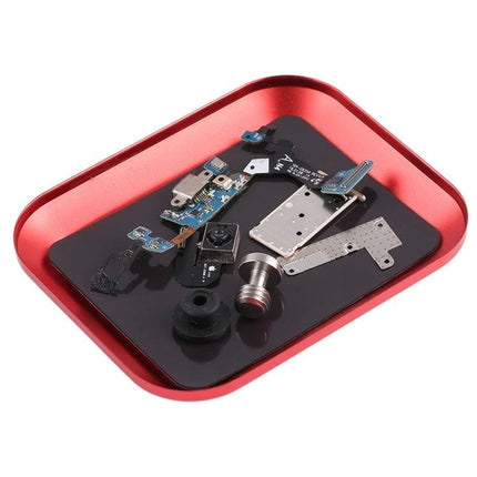 Red Magnetic Aluminum Alloy Screw Tray for Phone Repairs holding small phone components on a workbench