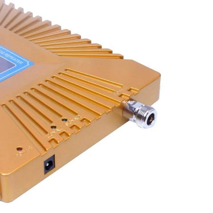 Compact Mini Signal Repeater for Mobile Coverage in Homes and Offices gold unit close-up showing antenna connector and power port