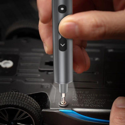 28-in-1 Precision Electric Screwdriver for Home Repairs used in electric mode to remove a small screw from a toy car