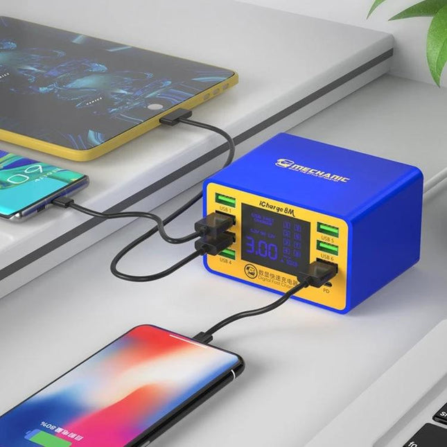 Mechanic iCharge 8M USB Smart Charger with LCD Display and Fast Charging charging multiple devices on desk with blue charger and LCD screen