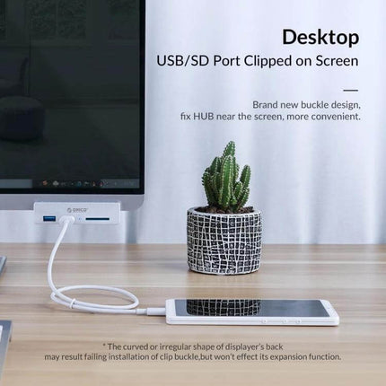ORICO Clip-Type USB 3.0 Hub with 2 Ports and SD Card Reader clipped to monitor showing USB cable and phone on desk
