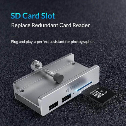 ORICO Clip-Type USB 3.0 Hub with 2 Ports and SD Card Reader clipped to monitor showing SD card inserted and two USB 3.0 ports