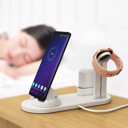 A Rotatable Charging Base for Everyday Home Device Needs showing phone upright, smartwatch and earbuds charging on a white rotating dock