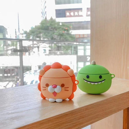 Daily Use Lion Design Protective Case for AirPods — orange lion silicone case on wooden sill with green companion case