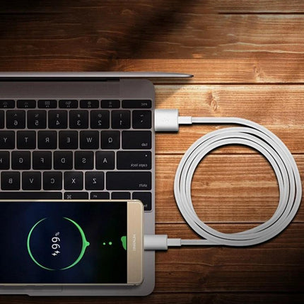 Essential USB-C Cable for Daily Device Charging Needs charging phone from laptop and coiled cable on wooden desk
