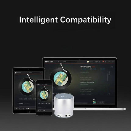 EWA Compact Bluetooth Speaker For Home And Commute small silver speaker beside phone tablet and laptop showing compatibility