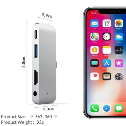 Versatile 4-in-1 USB-C Hub for Video and Presentations compact aluminum hub with HDMI, USB-A, USB-C power and audio ports beside smartphone