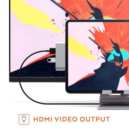 Versatile 4-in-1 USB-C Hub for Video and Presentations connected to tablet and monitor showing HDMI video output for mobile professionals