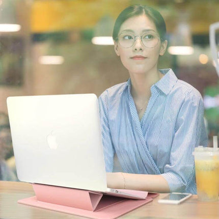 Waterproof PU Leather Universal Laptop Holder Bag for Travel shown in pink stand with laptop used by woman in cafe