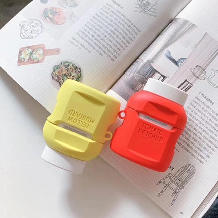 Fun Ketchup-Style Protective Case for AirPods on Daily Outings - red ketchup bottle AirPods case shown with mustard case on magazine