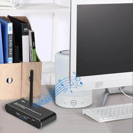 3-in-1 Bluetooth Receiver, Transmitter, and Digital to Analog Converter on desk streaming audio from PC to speakers