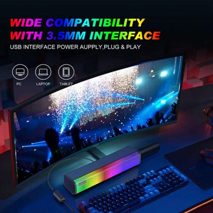 Compact Bluetooth Speaker For Home And Outdoor Portable Use shown with RGB lighting beside monitor, keyboard, and 3.5mm compatibility