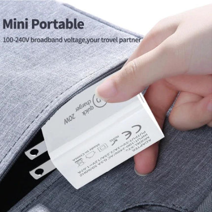 Compact Travel Charger for Daily Device Use on the Go - hand placing mini portable charger into bag pocket, compact and pocketable