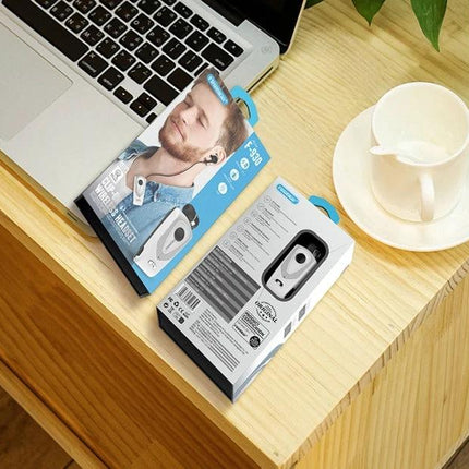 Retractable Bluetooth Headset For Hands Free Commuting silver F930 CSR4.1 packaging shown on desk with laptop and coffee cup