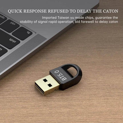 Bluetooth 5.0 USB Adapter for Wireless Computer Devices small black USB dongle next to laptop for wireless keyboards mice and headsets