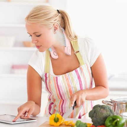 Rechargeable Hands-Free Neck Fan for Outdoor and Office Use worn by woman cooking in kitchen, hands-free cooling while chopping vegetables