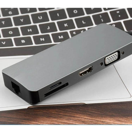Versatile 8-in-1 Type-C Adapter for HDMI and USB Connectivity compact hub showing HDMI, VGA, Ethernet and card slots on laptop