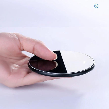 Sleek Mirror Wireless Charger for Daily Home Phone Use on a nightstand or desk, mirror-finish wireless charging pad held in hand