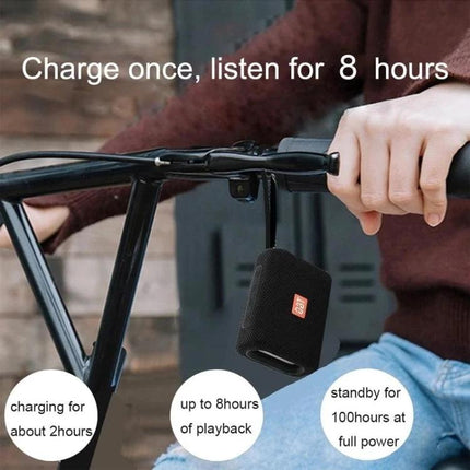 T G Compact Bluetooth Speaker For Outdoor Walks Picnics And Hikes hanging on bicycle handle showing 8 hours playback