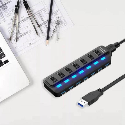 Seven-Port USB Hub with Independent Switch Controls for Multiple Devices shown on desk with laptop and tools, illuminated blue LEDs and individual port switches
