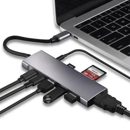 USB-C 9-in-1 Multi-Port Hub for Video, Data, and Charging Connections connected to laptop with HDMI, SD card, USB and charging cables