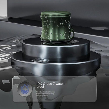 EWA Portable Speaker Pocket Sized For Travel And Jogging showing compact waterproof green speaker with water droplets