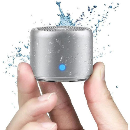 Compact Portable Bluetooth Speaker For Travel And Home Use in stainless steel, water-resistant, pocket-sized, hand-held, travel-ready