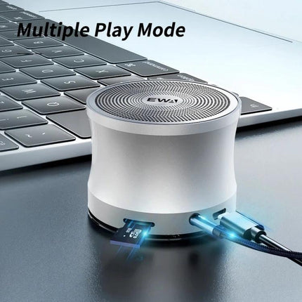 EWA Compact Bluetooth Speaker For Commutes, Travel And Home Use shown next to laptop with aux and USB connections