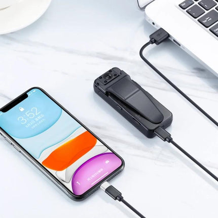 Clip-On Pen Camera for Daily Activities and Travel clipped to pocket and charging beside smartphone and laptop