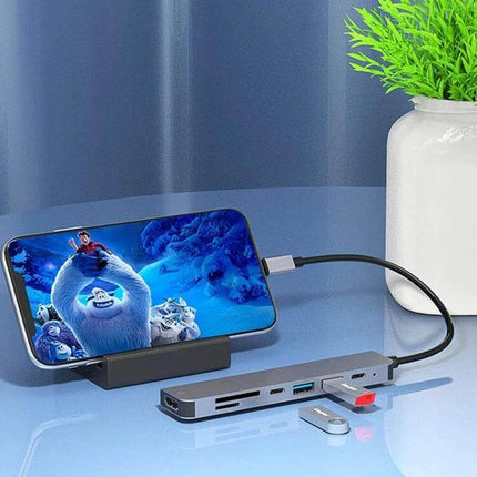 USB C Multiport Hub for Expanding Laptop Connections with HDMI connected to phone, HDMI out, SD card slot, PD charging and USB devices