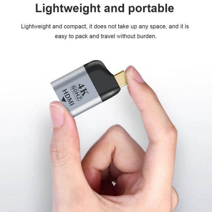 USB-C to HDMI Adapter for Connecting Devices to External Displays lightweight portable 4K adapter held between fingers