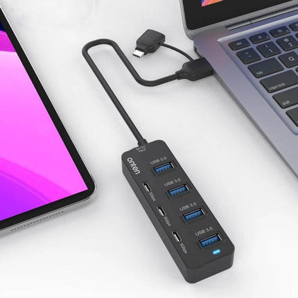 Onten 7-Port USB Hub for Connecting Multiple Devices Daily - compact hub with USB-C and three USB-A ports connected to laptop and tablet