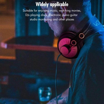 Yanmai Foldable Over Ear Headphones For Comfortable Travel Use shown folded pink earcups on a commuting musician