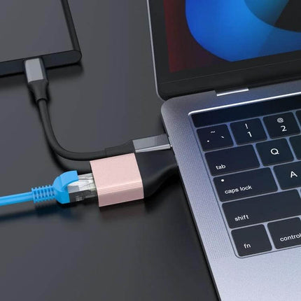 Onten UC101 Type-C Ethernet Adapter for Laptop Connectivity plugged into USB-C laptop port with blue Ethernet cable for stable wired internet