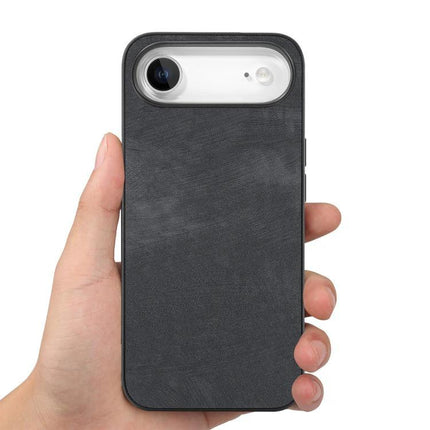 Vintage Leather Phone Case For Everyday iPhone Protection - black leather case held in hand showing rear camera cutout and slim profile