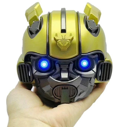 Bumblebee Compact Bluetooth Speaker For Home And Travel held in hand with glowing blue LED eyes and portable design